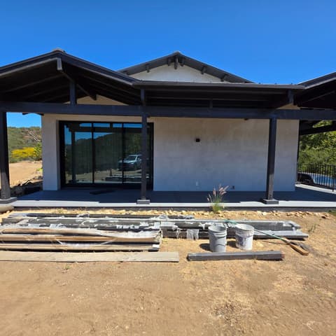 A newly built hillside home with its covered patio and glass doors cleaned before move-in